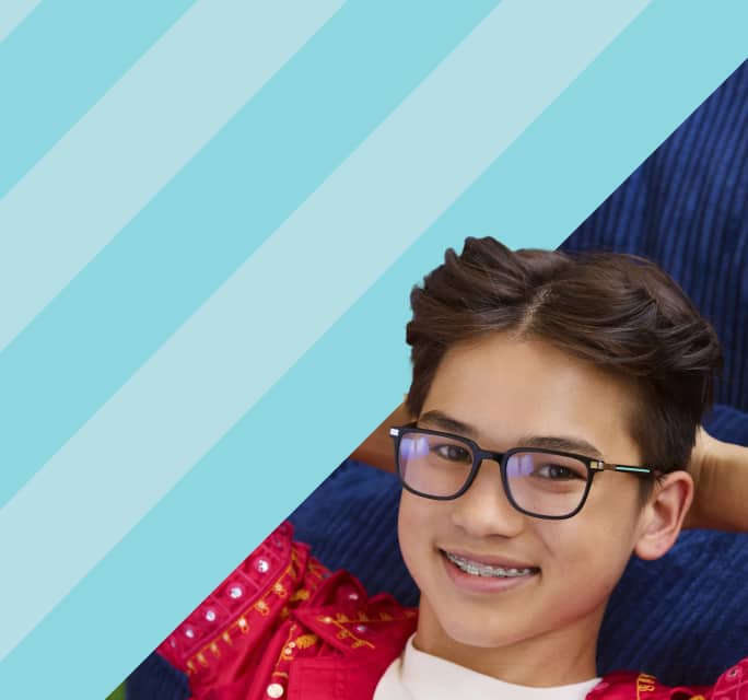 Smiling teenage boy with braces resting with his hands behind his head, wearing rectangular black eyeglasses, set against a dark blue background with light turquoise diagonal stripes on the left.