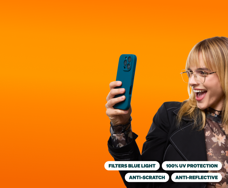 A young woman with blonde hair, wearing thin-framed glasses, smiles while holding up a teal phone as if taking a selfie. She is dressed in a black blazer over a floral top. The background is a vibrant orange gradient. At the bottom, four white text bubbles highlight the glasses' features: Filters Blue Light, 100% UV Protection, Anti-Scratch, and Anti-Reflective.