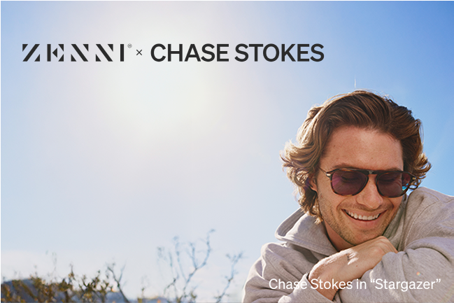 Chase Stokes wears a pair of ‘Stargazer’ tortoiseshell aviator sunglasses with tinted lenses. He is outdoors, smiling with tousled hair, dressed in a hoodie, under a bright sunlit sky.