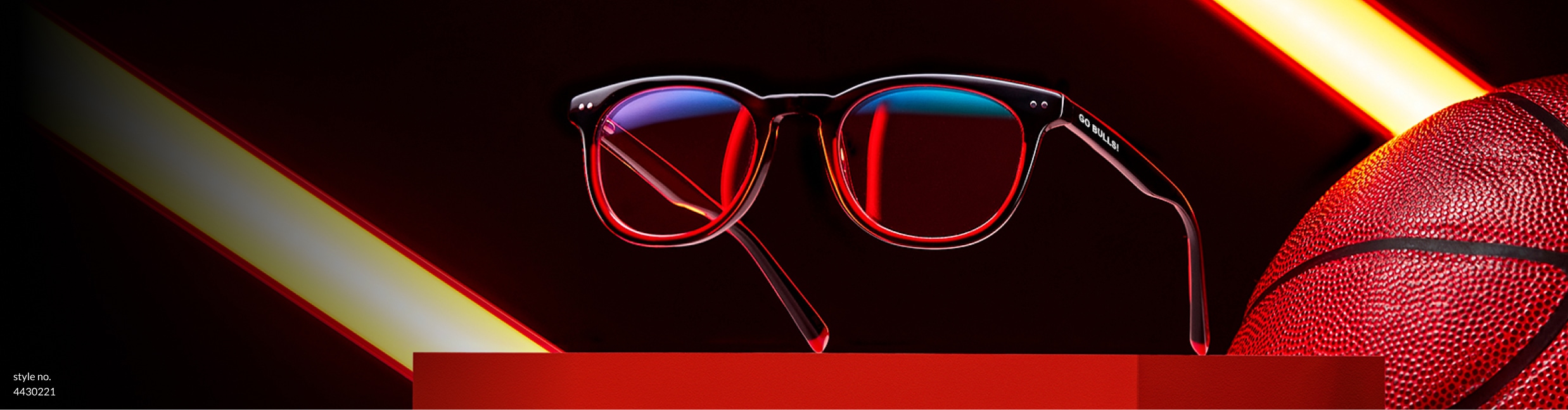 Zenni black and red round glasses Rim Rocker #4430221, displayed on a red platform next to a basketball.