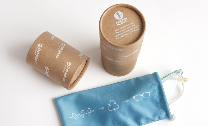 Image of Zenni ReMakes glasses inside of a pouch, with a cardboard tube next to it, made from sustainable materials. 