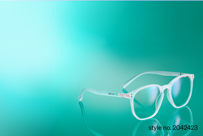 A pair of translucent white glasses style number 2042423 rests on a glossy teal surface. The left frame arm features the ‘ghost’ logo.