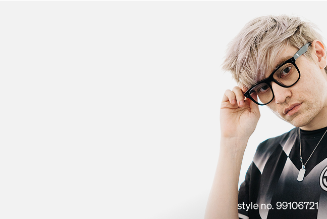 Leffen, wearing black square glasses style no. 99106721 and black and white TSM jersey, adjusts his frames while gazing at the camera against a plain white background.