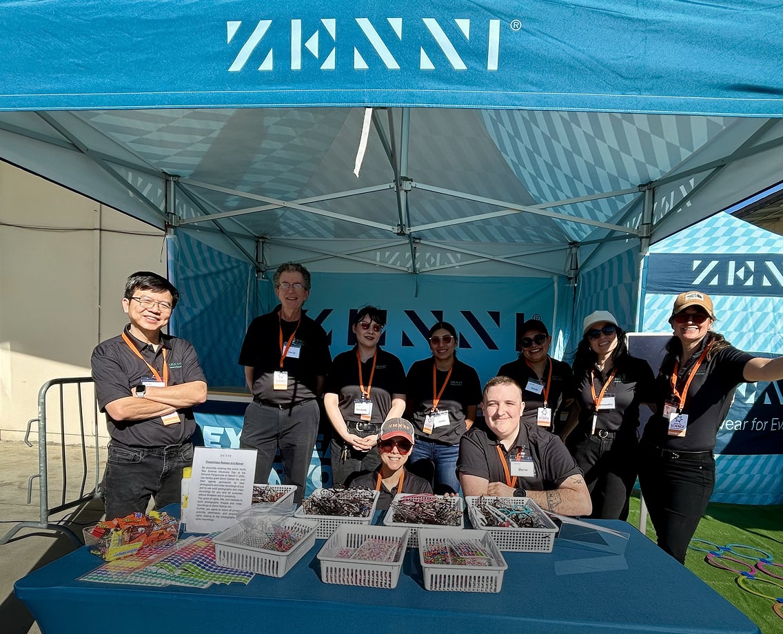 Nine members of the Zenni Team inside the Zenni event booth.