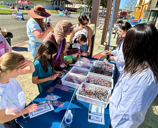 Zenni team members helping children decorate glasses.