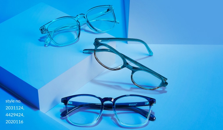 Image of three pairs of Zenni glasses: square #2031124, oval #4429424, and square #2020116 on white platforms, bathed in blue light.