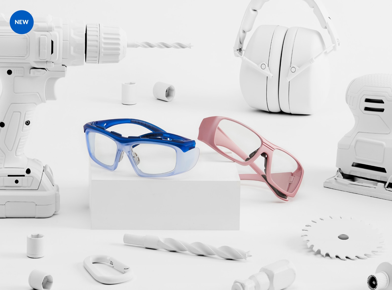 New. Image of Zenni Z87.1 safety glasses #748916 and #749119 on a white platform, surrounded by tools that are painted white.
