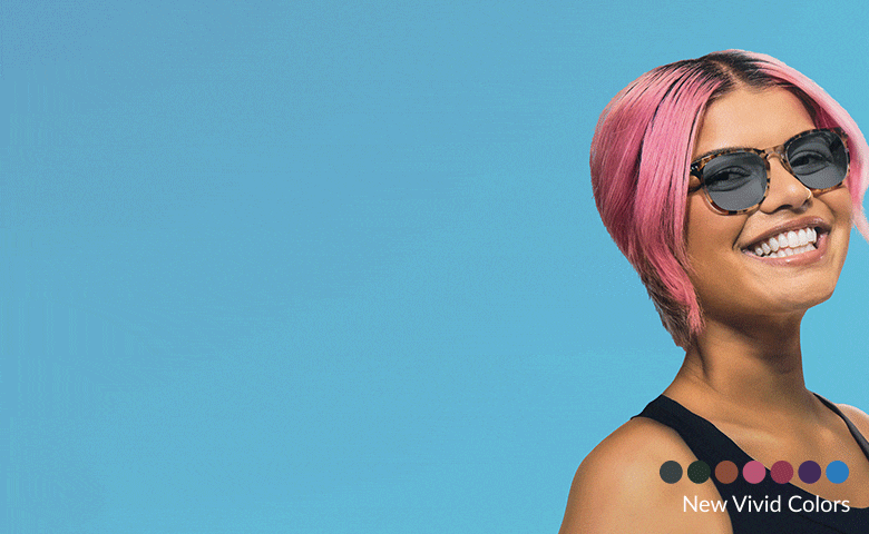 Smiling person with pink hair wearing purple-tinted sunglasses against a blue background. There is a row of color swatches labeled 'New Vivid Colors.'