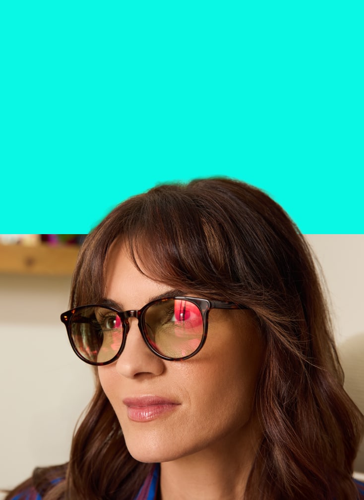 Close-up of woman wearing EyeQLenz with Zenni ID Guard glasses with a subtle pink sheen on lenses.
