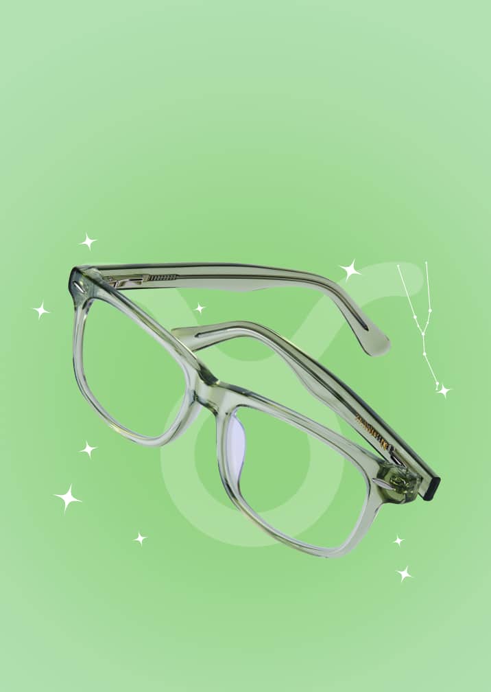 Neutral-toned rectangular eyeglasses on a green zodiac background with the Taurus symbol and constellation.