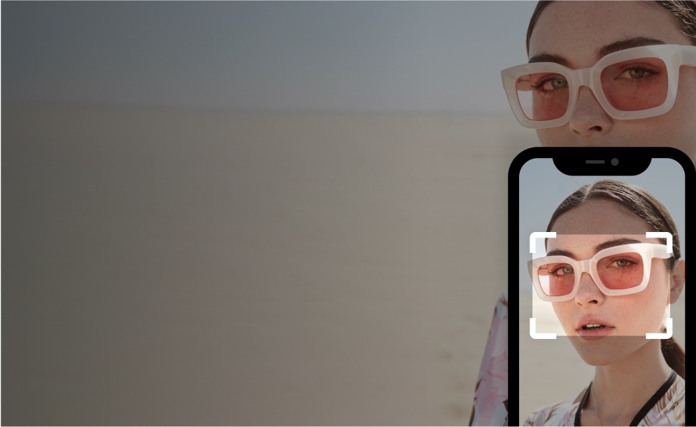 A woman wearing square glasses with an overlay of a phone taking a picture of the woman and a rectangle focusing on the glasses.