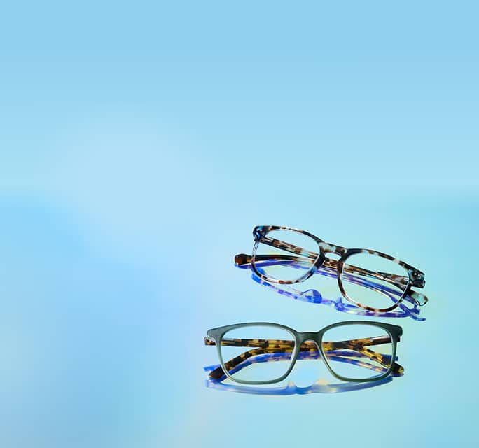 Group of two Zenni eyeglasses on light blue gradient background.