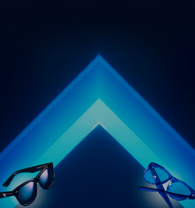 Pair of black sunglasses with mirrored lenses next to blue semi-rimless eyeglasses on a blue gradient background.