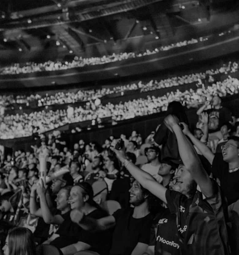 Dreamhack x Zenni partnership logo. Dark arena with crowd and teal hue, with a text overlay communicating that Zenni is the Official Eyewear of Dreamhack.