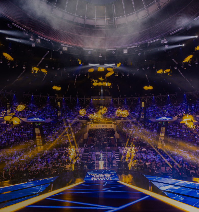 The ESL stage in an arena, lit with blue and yellow stage lights.