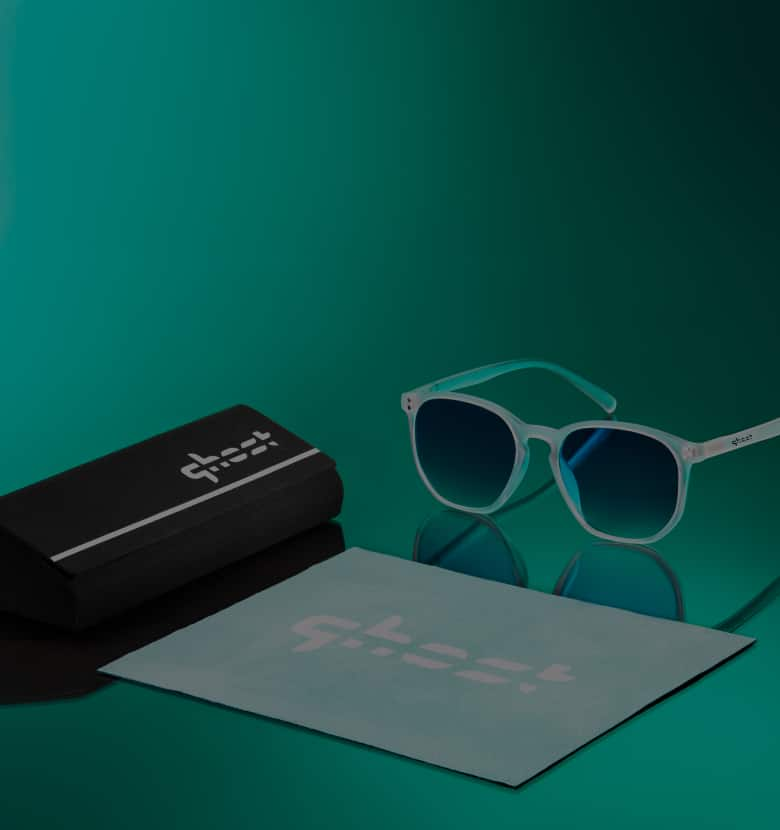 White-rimmed sunglasses with dark lenses on a green background. Text reads: "Zenni x Ghost Gaming. Official Eyewear of Ghost Gaming. Show your love for Ghost Gaming with a curated collection of eyewear." There is a "Shop Now" button below.