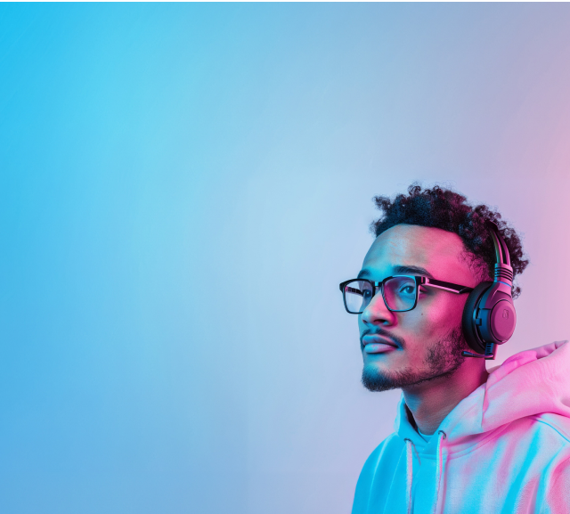 Man in a hoodie wearing headphone with Zenni gaming square glasses.