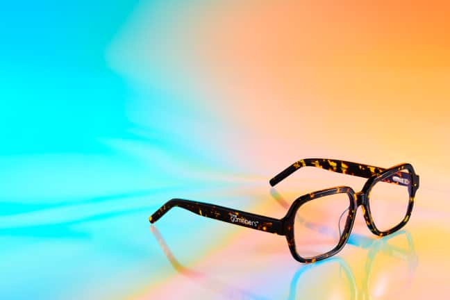 Banner promoting the*gameHERS Favorite Glasses with a featured pair of tortoiseshell Zenni frames on a vibrant gradient background.