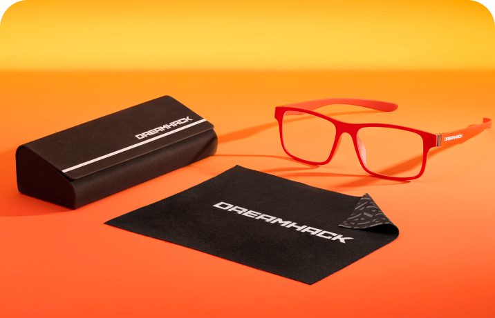 Dreamhack branded Zenni eyewear set with dark orange glasses, black case, and cleaning cloth on orange background.