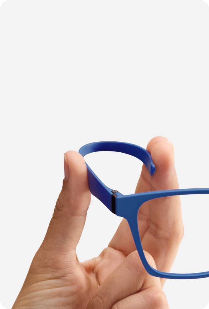 A hand holding a pair of blue Zenni OptiFlex glasses made of ULTEM material, highlighting ultra-lightweight and flexible properties.