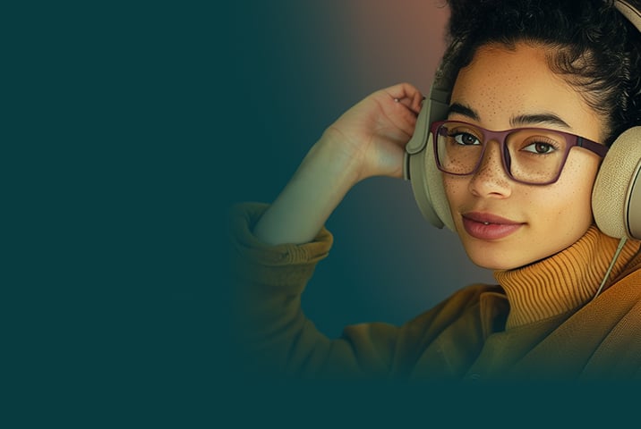 A woman wearing headphones and glasses.