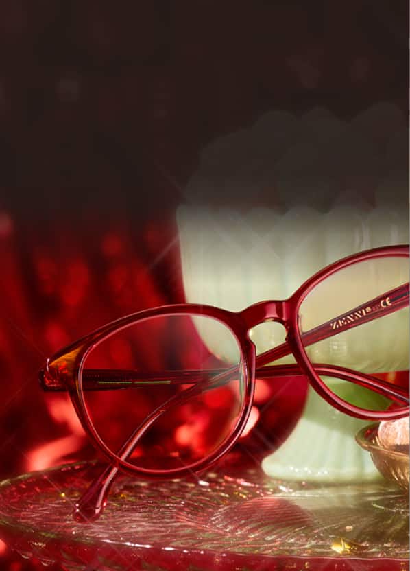 Blokz® tortoiseshell eyeglasses with blue light filtering lenses on dark holiday sparkle background