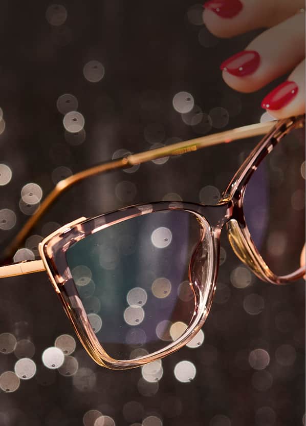 Zenni cat-eye reading glasses on holiday sparkle background with warm lighting