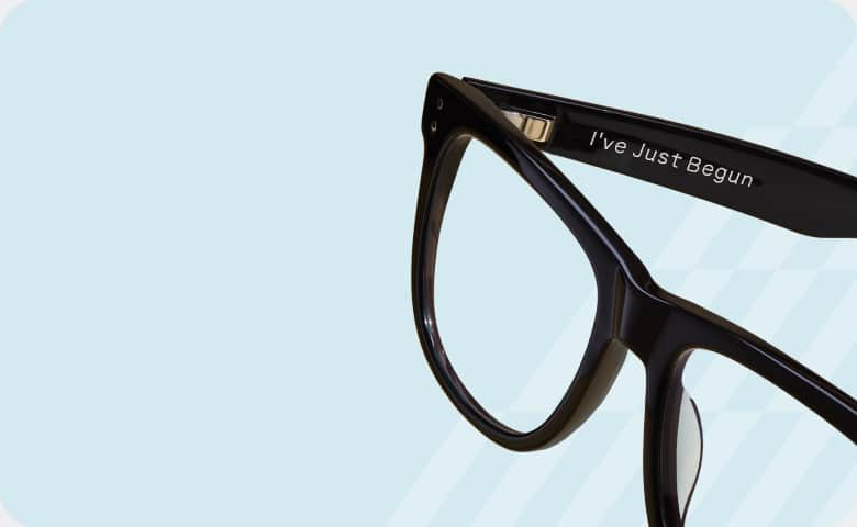 Black Zenni frames engraved with 'I've Just Begun,' symbolizing empowerment and upliftment for Zenni’s Vision of Wellness collection.