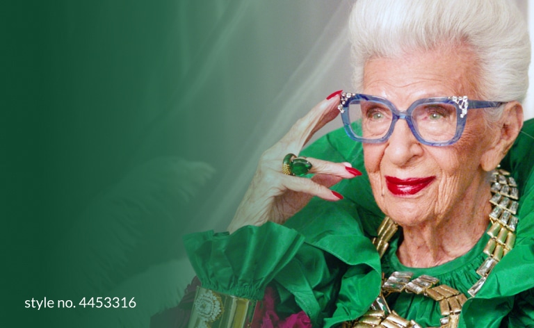 Image of Iris Apfel wearing puttin’ on the glitz square glasses #44533 against a silver curtain background. 