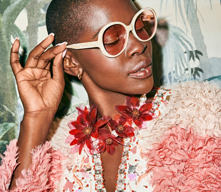 A Black women rocking iconic patterned round frame.