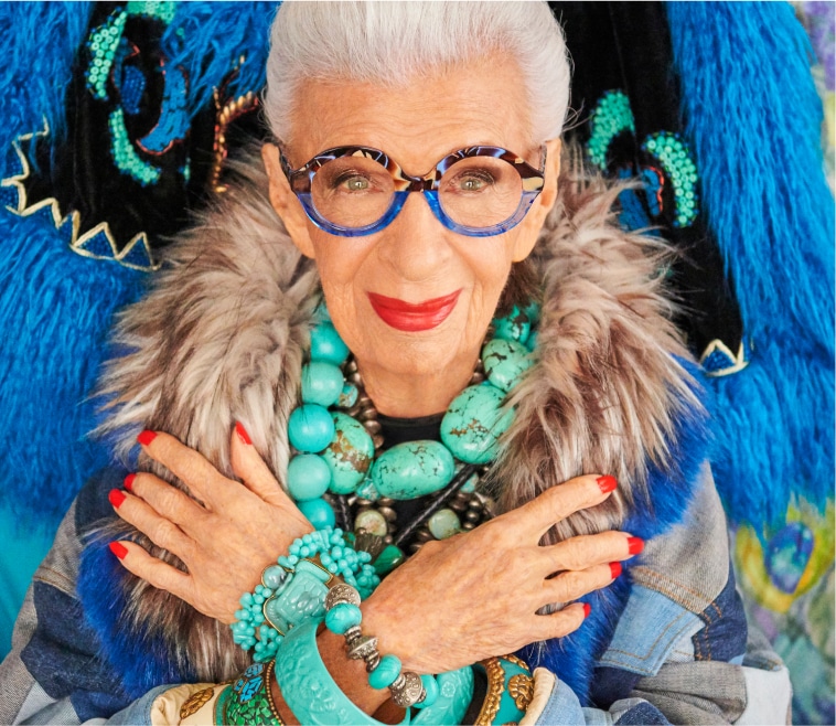 Iris Apfel rocking round blue and brown patterned glasses.