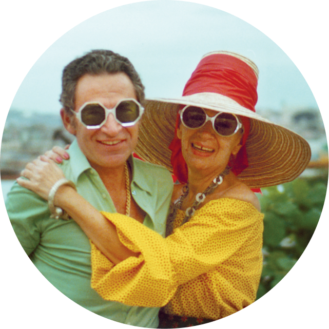 Image of Iris Apfel and her husband, Carl, wearing fun statement glasses on vacation.