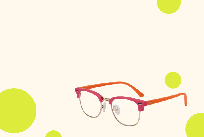 Red browline kids’ glasses on a beige background with green circles.