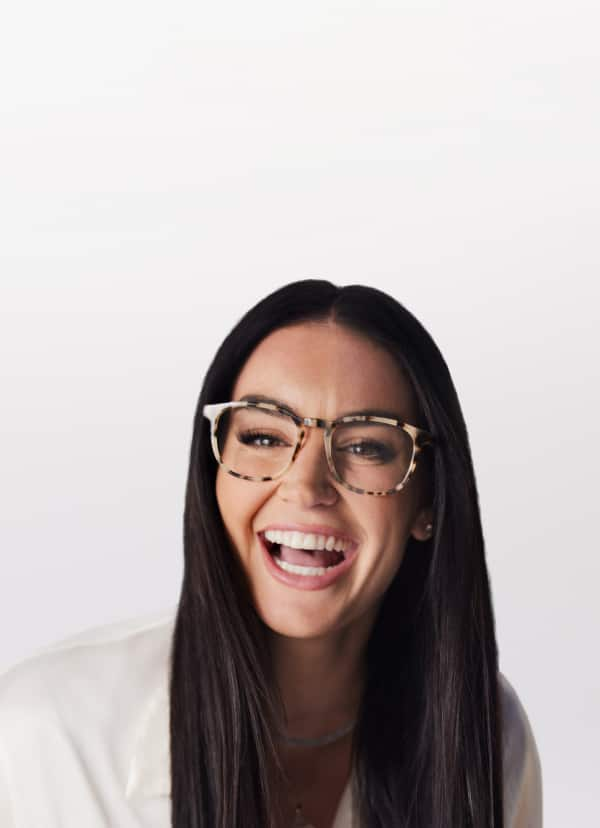 Claire Kittle, long black hair, laughing, wearing bold tortoiseshell Zenni Travelers square glasses #4448935.