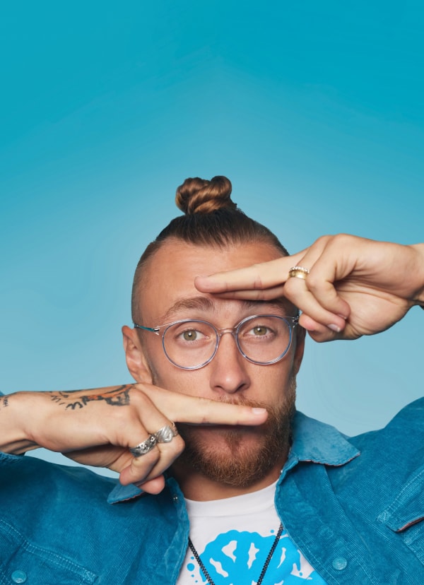 Close-up of George Kittle, 49er, with his fingers framing his eyes, wearing Zenni Stone Cold round glasses #7827016.