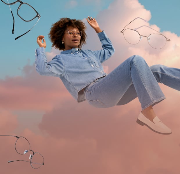 A woman with curly brown hair wearing lightweight geometric glasses, floating in a semi-reclined position in front of a background of pink clouds and blue sky. More pairs of lightweight glasses are floating around her.
