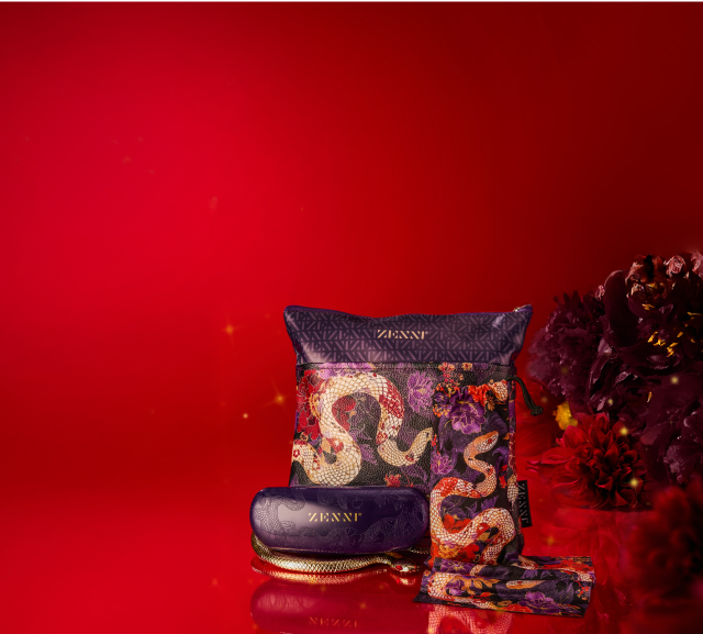 A matching accessory set includes a Zenni-branded glasses pouch, cloth, and case. The items have intricate snake-themed patterns in gold, purple, and red tones, accompanied by bold flowers.