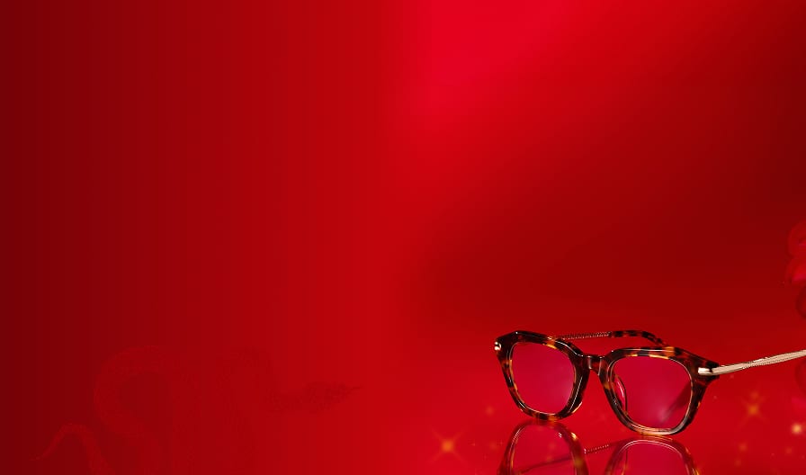 A vibrant red background features eyeglasses 'Serene Allure'. A faint snake silhouette weaves subtly across the design, surrounded by soft floral accents for a luxurious feel.