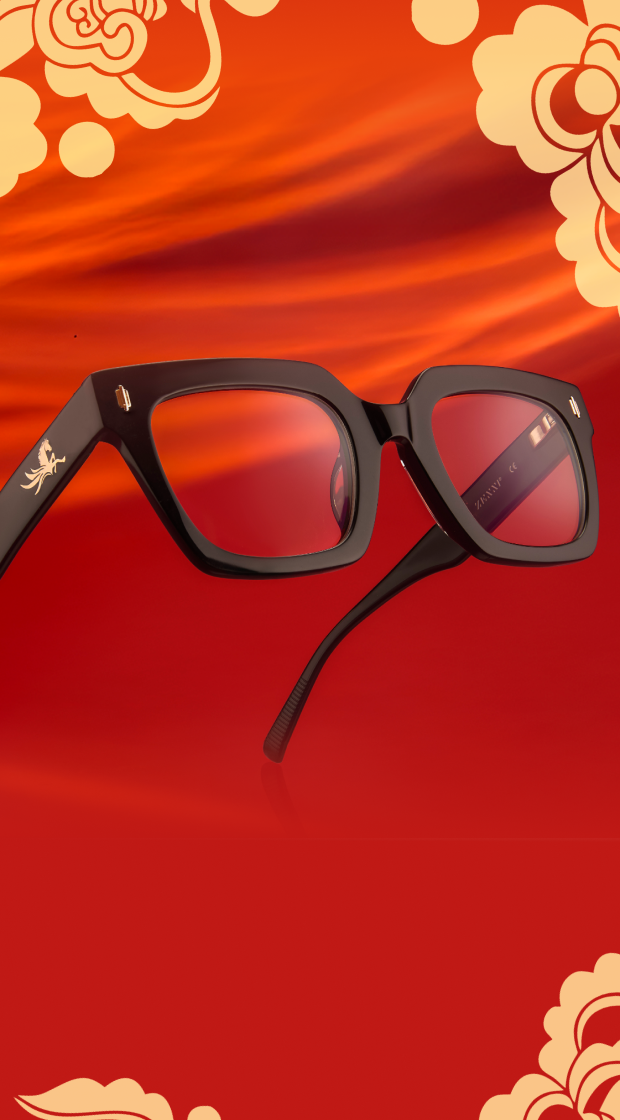 Black thick-rim square Zenni glasses with a gold horse design on the temple arm, surrounded by a gold floral horse motif over a red background. Additional text: Free gift with purchase while supplies last.