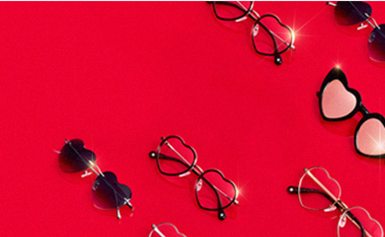 Several rows of heart-shaped glasses on a bright red background.