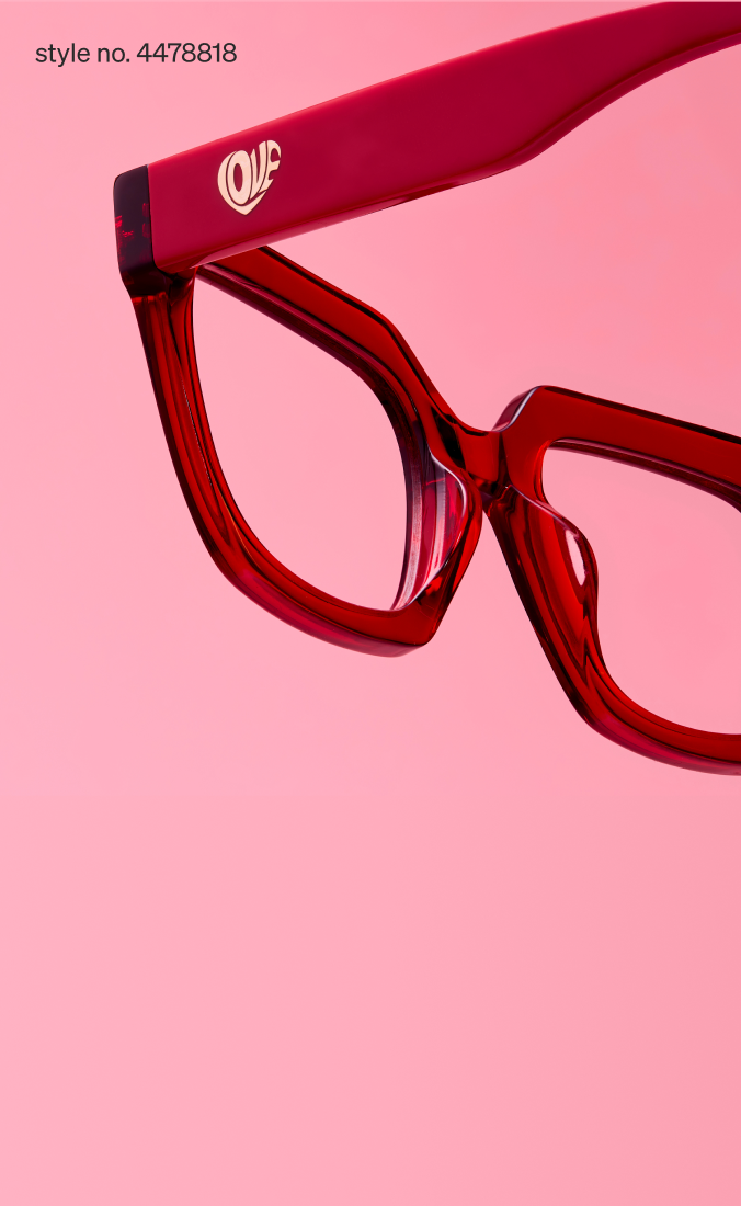 Close-up of red translucent eyeglasses with ‘LOVE’ branding on the temple against a pink background. Style no. 4478818.