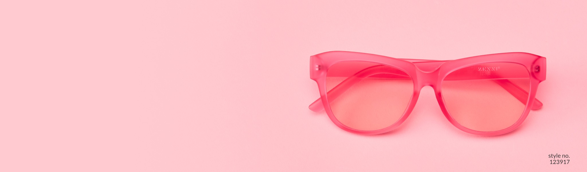 Image of Zenni pink cat-eye glasses #123917 on a pink background.