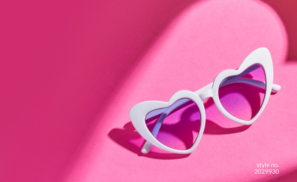 Image of Zenni heart-shaped frame #2029930 shown with lavender lens tint against a neon pink background.