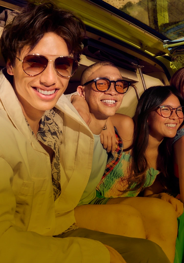 Group of four friends smiling together wearing Zenni glasses.
