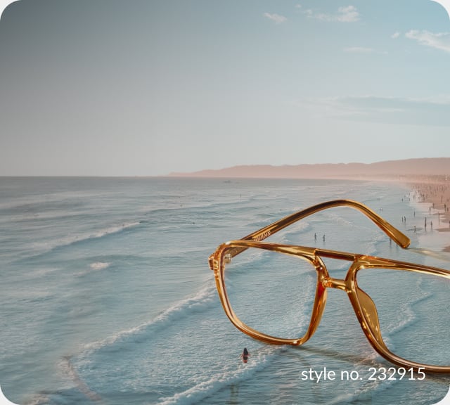 A serene beach scene at sunset, the shoreline is dotted with people, and the oversized translucent amber aviator glasses style no. 232915glasses are positioned prominently in the foreground, floating above the waves.