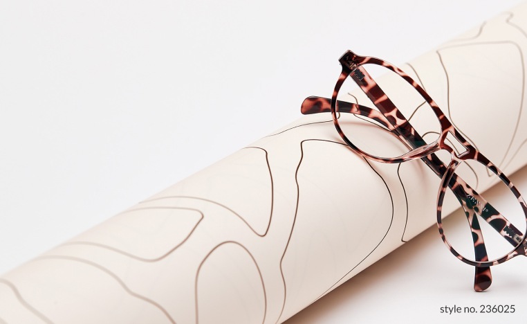 Image of a pair of Zenni aviator glasses #236025 against a roll of animal print wrapping paper.