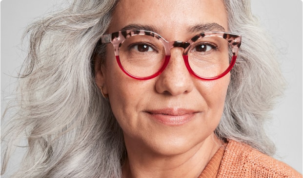 Image of a woman wearing Zenni progressive glasses against a gray background..
