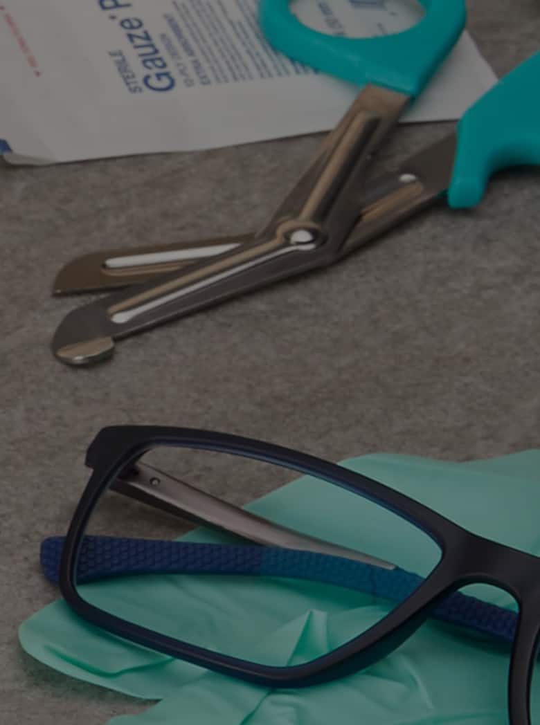 Blue rectangle glasses #7815716 next to an EMT bag and bandages.