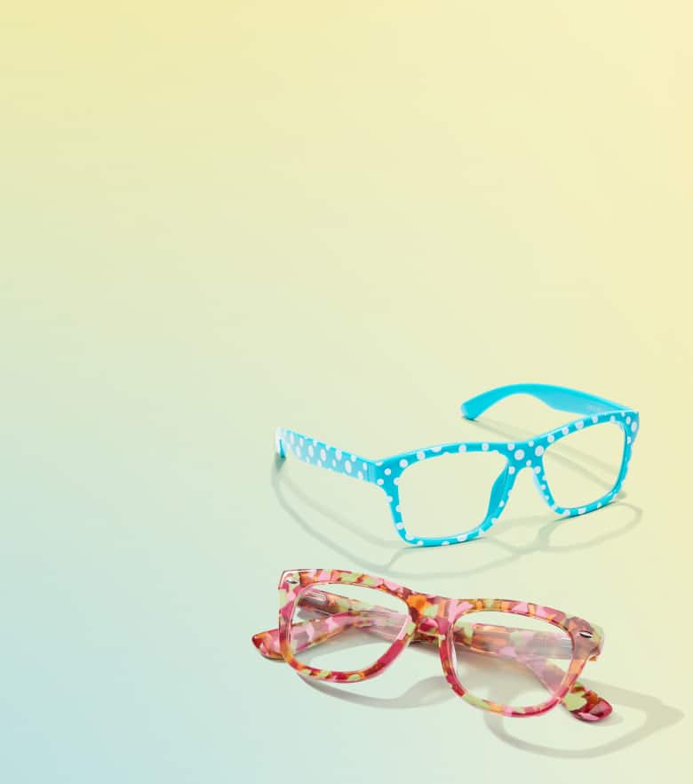 Sky blue polka dot rectangle frame and patterned red rectangle glasses, on a blue to yellow gradient background.
