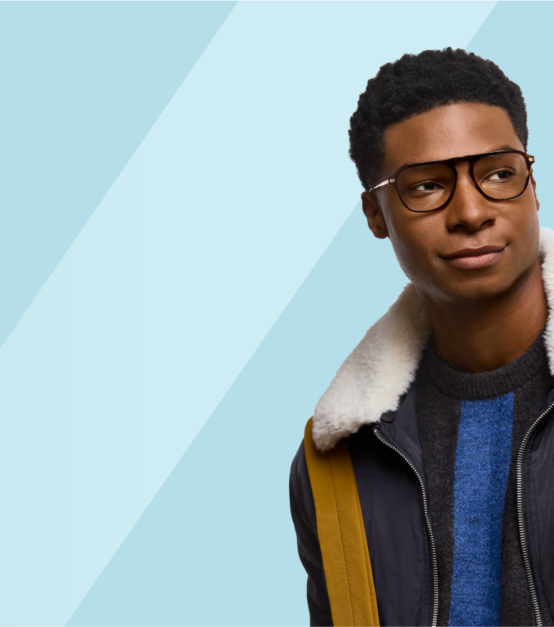 A stylish young man with short curly hair wearing classic tortoiseshell aviator glasses, looking confidently to the side, set against a light blue background with diagonal stripes.